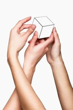 Hands holding white cube Foto stock