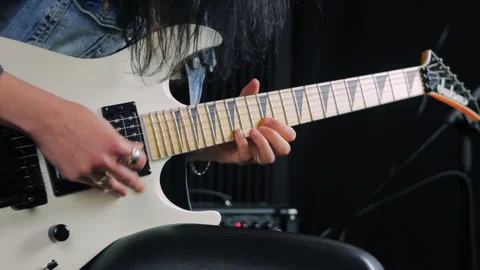 Hands holding a white electric guitar and playing a fast solo Stock Footage
