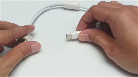 Hands holding white usb type c charger cable wire close up Stock Footage 340860927