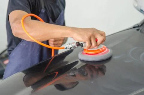 Hands holding the work tool polish car. Stock Photos