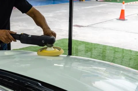 Hands holding the work tool polish car. Stock Photos