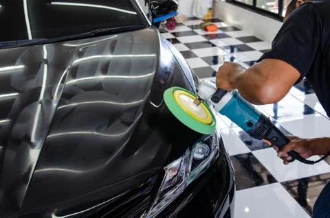 Hands holding the work tool polish car. Stock Photos