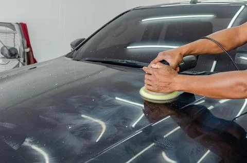 Hands holding the work tool polish car. Stock Photos