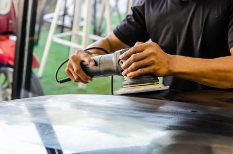Hands holding the work tool polish car. Stock Photos