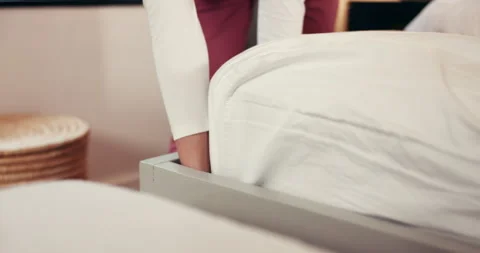 Hands, housekeeping and making bed with person in hotel room for hospitality or Stock Footage 312659197