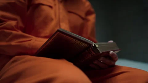 Hands of Inmate Reading Bible in Prison Cell Stock Footage 263254369