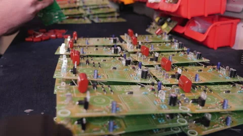Hands inserting electronic component into printed circuit board - close up Stock Footage 139515432