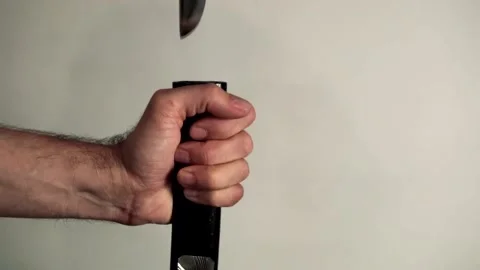 Hands inserting Japanese sword Stock Footage 93998418