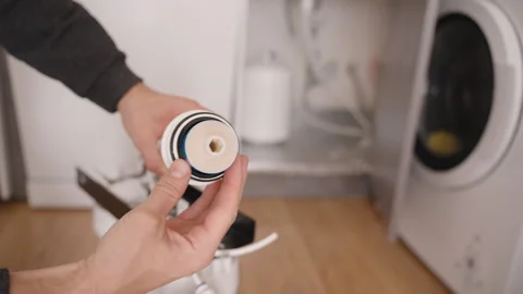 Hands Inserting a New Blue Reverse Osmosis Membrane Filter into the System, Stock Footage 296572138