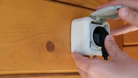 Hands inserts the plug into the socket. Stock Footage 156815196