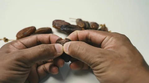 Hands Inspecting Date Fruit Close-Up, Close-up of hands holding and inspect.. Stock Footage 304974948