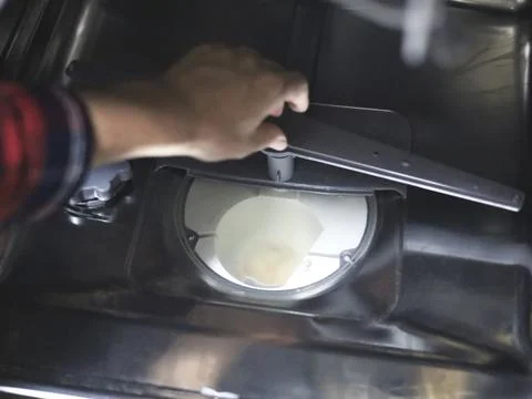 Hands Inspecting Dishwasher Interior For Maintenance Stock Photos