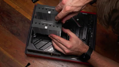 Hands installing CPU cooler on motherboard. Ideal for tech tutorials or Stock Footage 301636081