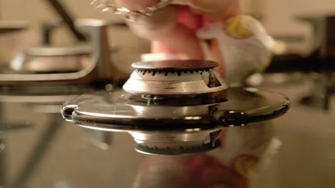 Hands installing gas stove grill after cleaning, Kitchen appliance maintenance Stock Footage 212909652