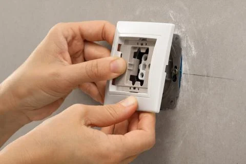 Hands installing light switch Stock Photos