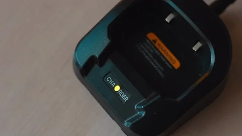 Hands installing a walkie-talkie to charge close-up macro shot Video stock 128342187