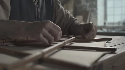 Hands of a inventor tying a knot on a flying machine wooden wing frame 스톡 동영상 339232599