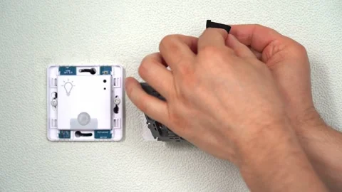 Hands isolate wires using electrical tape in outlet. Installing socket Stock Footage 279078896