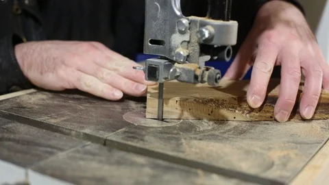 Hands of a joiner process a tree on a band saw. Production of wooden boards for  動画素材 123453690