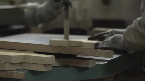 Hands of joiner using band saw, factory worker cutting board on blade, close up. 動画素材 87854829