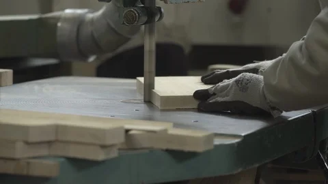 Hands of joiner while sawing timber with band saw close up,factory,change focus. Stock Footage 88013997