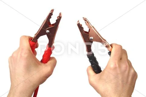 Hands with jumper cables on white Stock Photos