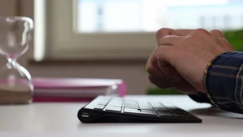 Hands on the keyboard at the table, thinking where to start Video stock 244599169