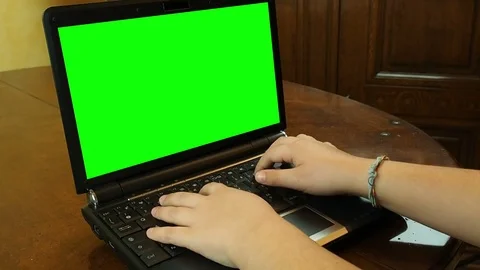 Hands kid or child typing on keyboard laptop with green screen Stock Footage 72685228