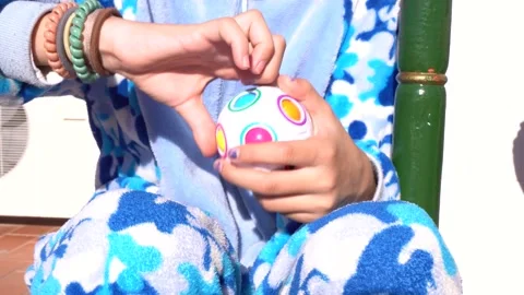 Hands of kid in pajama playing with educational puzzle toy to improve memory Stock Footage 167141624