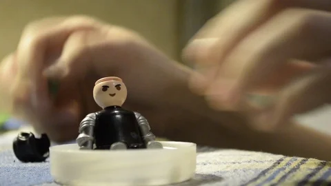 Hands of a kid playing with a plastic toy doll Stock Footage 102415828