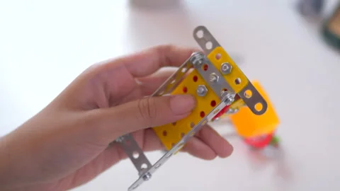 Hands of the kids Assembling DIY 3D-Printed Robot Parts Stock Footage 322572665