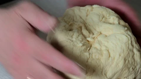 Hands knead the dough . Stock Footage 229688506
