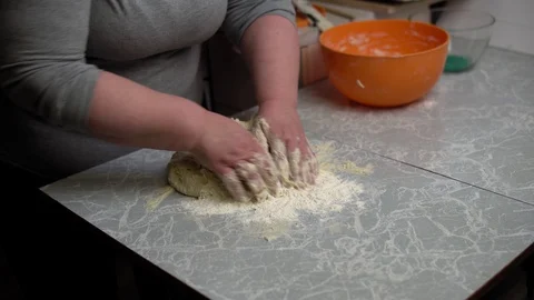 Hands knead the dough on the kitchen table. Stock Footage 120899407