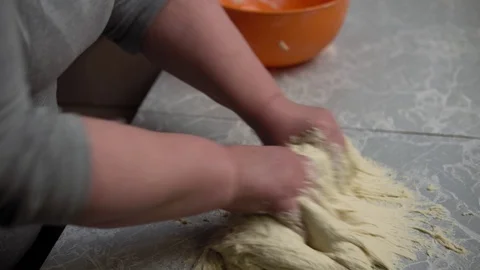 Hands knead the dough on the kitchen table. Stock Footage 123441268