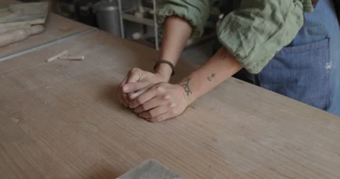 Hands knead soft clay, preparing it for sculpting. The tactile process Stock Footage 301455564