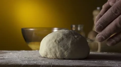 Hands kneading bread dough on a cutting board Stock Footage 21765241