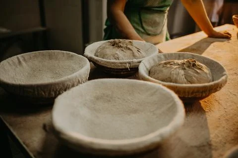 Hands kneading bread dough on a cutting board Stock Photos