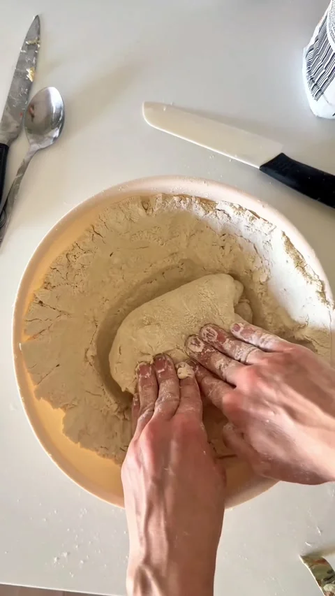 Hands Kneading Bread Dough on Floured Surface Top View Baking Scene vertical Stock Footage 307829614