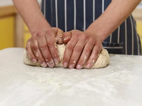 Hands kneading bread Stock Photos