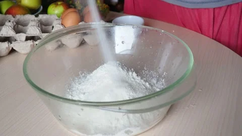 Hands kneading dough in flour, adds egg to flour, baking powder, sugar Stock Footage 170901094