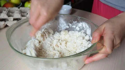 Hands kneading dough in flour, adds egg to flour,  baking powder, sugar Stock Footage 170901280