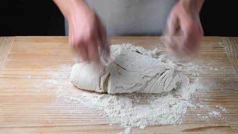 Hands kneading dough for Italian pizza on kitchen worktop. Stock Footage
