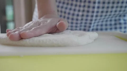 Hands Kneading Dough on a Kitchen Counter Stock Footage 314786718