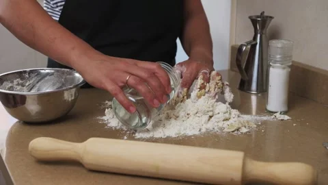 Hands Kneading Dough on a Kitchen Counter Surrounded by Baking Tools Stock Footage 316088306