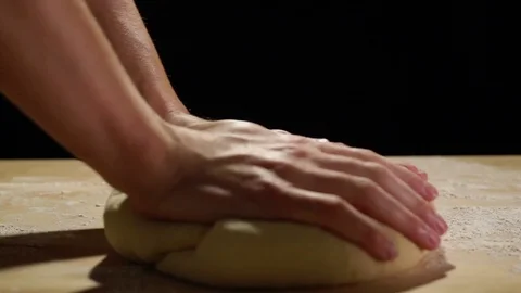 Hands Kneading Dough In Slow Motion On Wood Table and Black Background Stock Footage 82149229