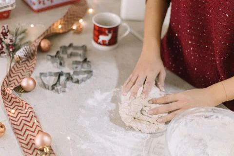 Hands kneading dough on table with cookie forms Stock Photos