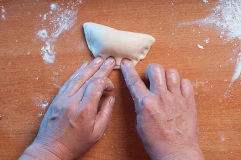 Hands kneading dough on the table Stock Photos