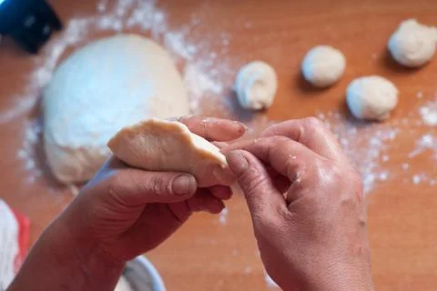 Hands kneading dough on the table Stock Photos