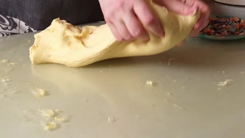 Hands kneading enriched dough with dried fruit for baking homemade bread Stock Footage 341935193