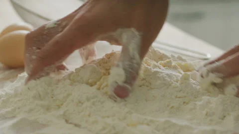 Hands Kneading Mixture of Flour and Eggs on Kitchen Table Stock Footage 288811334